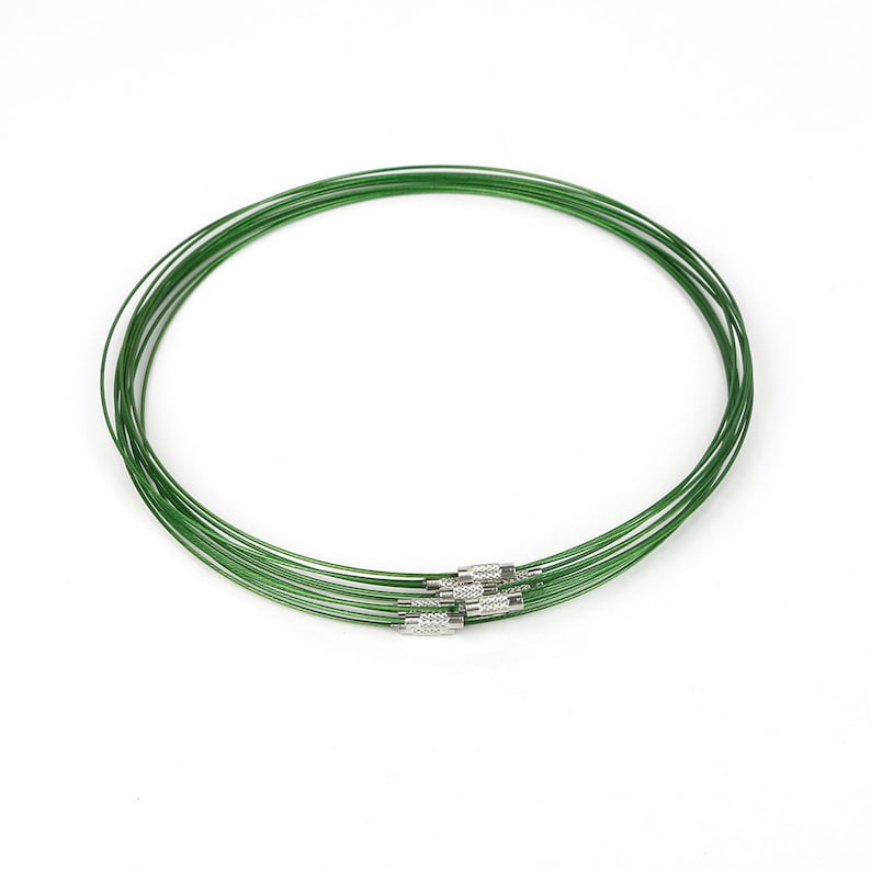 May include: A set of eight green metal necklaces with silver clasps. The necklaces are arranged in a circle.