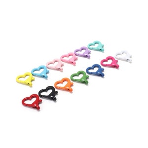 May include: A row of 12 heart-shaped metal clasps in various colours, including red, orange, yellow, green, blue, purple, pink, and white.
