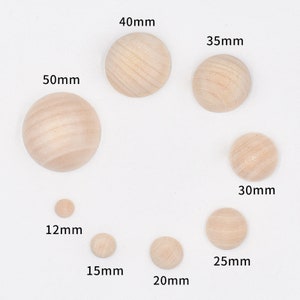 May include: Assortment of ten unfinished wooden circles in various sizes, ranging from 12mm to 50mm in diameter. The circles are smooth and have a natural wood color.