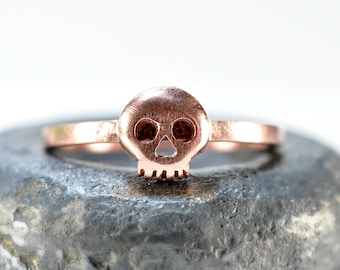 Tiny skull ring in strawberry glaze made from sterling silver and plated in rose gold