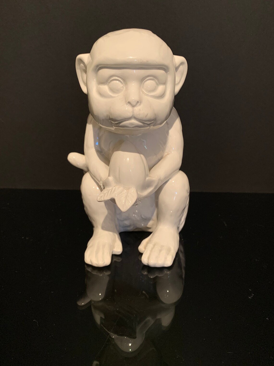 White glazed ceramic monkey statue eating a piece of fruit by Etsy
