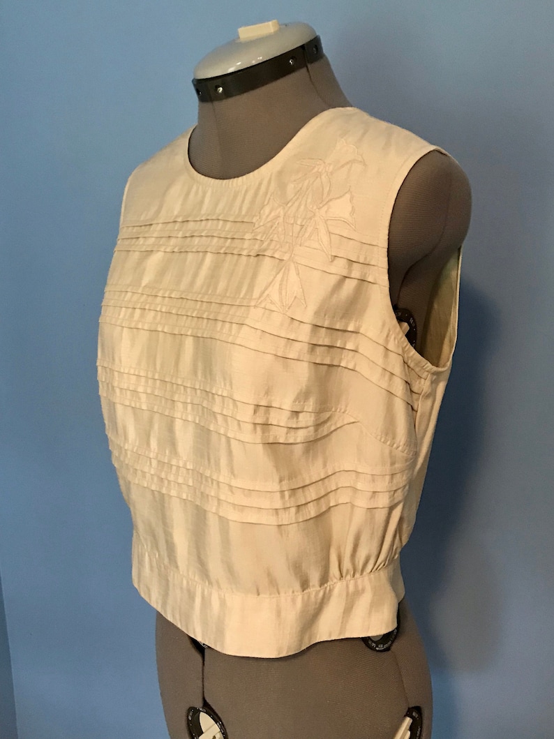 Ivory Pleated Silk Look Blouse with Floral Appliqu\u00e9