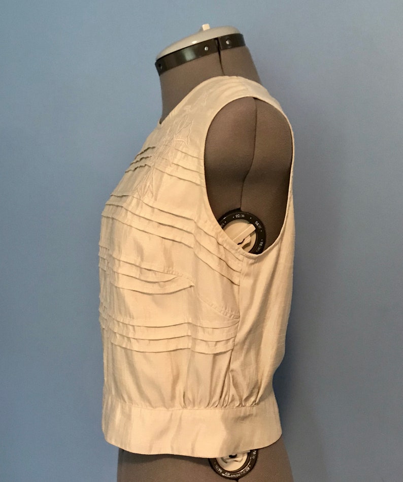 Ivory Pleated Silk Look Blouse with Floral Appliqu\u00e9