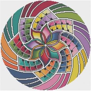 Puede incluir: Un diseño circular colorido con una flor en el centro. La flor tiene seis pétalos y está rodeada por un patrón de rayas y cuadrados en espiral en tonos de rojo, naranja, amarillo, verde, azul, morado y rosa.