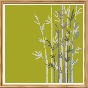 Könnte beinhalten: Ein gerahmtes Kreuzstich-Design mit einer stilisierten Darstellung von Bambusstangen in Grautönen und Weiß vor einem einfarbigen grünen Hintergrund.