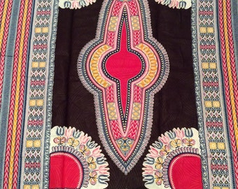 May include: A black fabric with a red, yellow, and white geometric pattern. The pattern features a central diamond shape with a circle inside. The fabric is bordered by a blue, yellow, and red patterned trim.