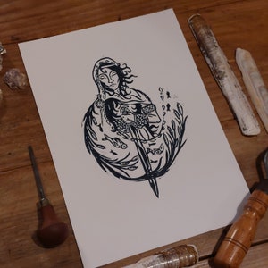 May include: Black and white linocut print of a woman holding a sword, surrounded by fish and seaweed.