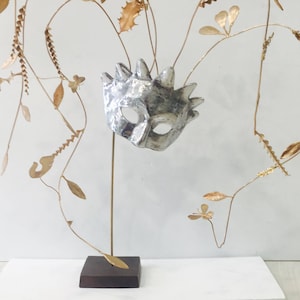 Metal sculpture,cast aluminum mask with bronze branches of leaves spirals and flowers, Greek art, Ancient Greek theatre mask, mask sculpture