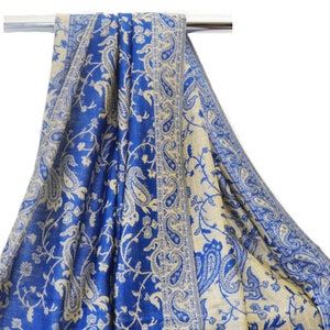 May include: A blue and cream paisley patterned shawl with a fringed edge.