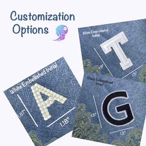 May include: Three different options for customizing a garment with initials. The first option is a white embellished initial "A" measuring 1.57 inches by 1.18 inches. The second option is a white embroidered initial "T" measuring 1.5 inches by 1.9 inches. The third option is a black embroidered initial "G" measuring 1.2 inches by 1.5 inches.
