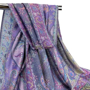 May include: A purple and blue paisley patterned scarf with gold accents. The scarf is folded and draped over a metal rod.