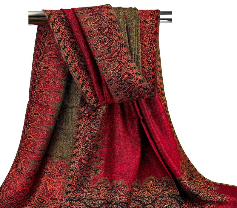 Pode incluir: Um xale vermelho e verde com padr&atilde;o paisley e borda franjada.