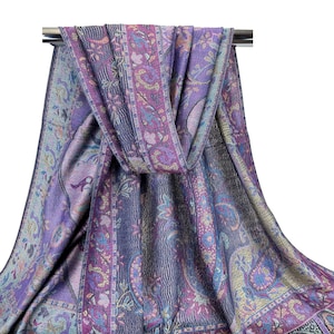 May include: A purple and blue paisley patterned scarf with gold accents. The scarf is folded and draped over a silver rod.
