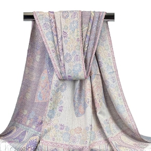 May include: A soft, lightweight scarf with a paisley pattern in shades of purple, pink, and white. The scarf is made of a blend of wool and cashmere and is perfect for adding a touch of elegance to any outfit.