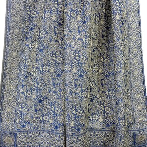 May include: A blue and white paisley patterned shawl with a fringed edge.