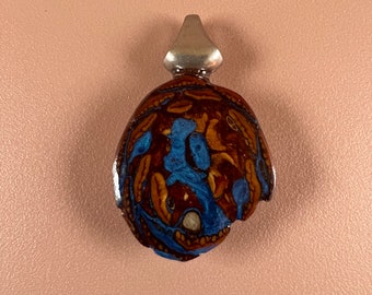 Pinecone and metallic blue inlay pendant.