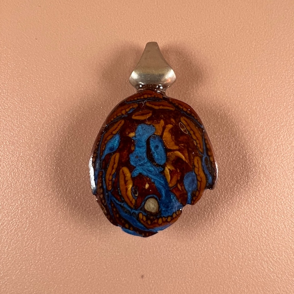 Pinecone and metallic blue inlay pendant.