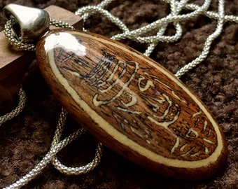 Mahogany Wood Carved Pendant with Magnesite Inlay of a Skeleton Man