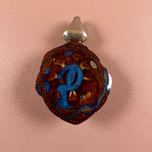 Pinecone and metallic blue inlay pendant