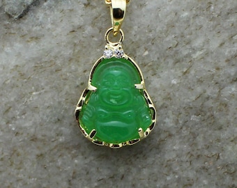 May include: A gold pendant necklace featuring a green jade Buddha charm with two small clear crystal accents.