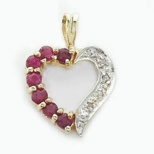 May include: A gold heart-shaped pendant with a ruby stone border and a diamond-encrusted side.