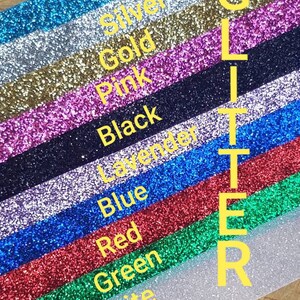 May include: A close-up of a variety of glitter colors, including turquoise, silver, gold, pink, black, lavender, blue, red, green, and white. The word "GLITTER" is written vertically in yellow letters.