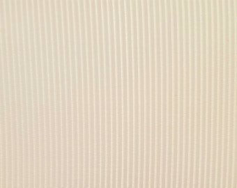 May include: A close-up of a white fabric with a subtle vertical ribbed texture.