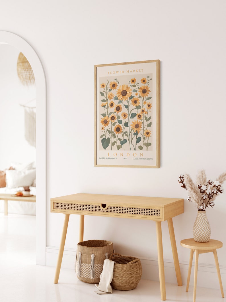 May include: A framed print of a botanical illustration of sunflowers with the text "FLOWER MARKET! LONDON" and the words "GALERIE D'ART MODERNE" and "COLLECTION BOTANIQUE" at the bottom.