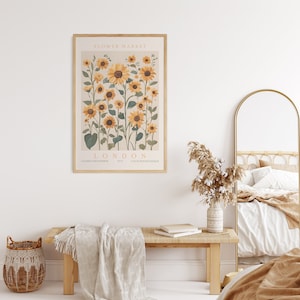May include: A framed print with a botanical illustration of sunflowers. The print has the text "FLOWER MARKET LONDON" and "COLLECTION BOTANIQUE" at the bottom.