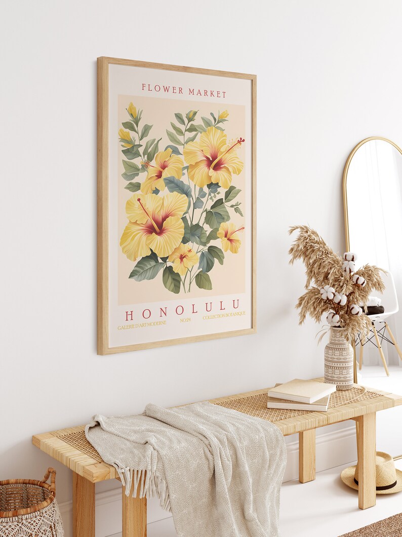 May include: A framed botanical print featuring yellow hibiscus flowers with red centers. The print is titled "FLOWER MARKET HONOLULU" with the text "GALERIE D'ART MODERNE" and "COLLECTION FROM HAWAII" at the bottom.