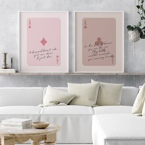 May include: Two printable art prints with pink backgrounds and white frames. The prints feature a playing card ace of diamonds and ace of clubs with inspirational quotes. The first print says "A diamond doesn't ask if it can shine. It just does." The second print says "In the deck of dreams, you are the ace. Play boldly and let success be your winning hand."