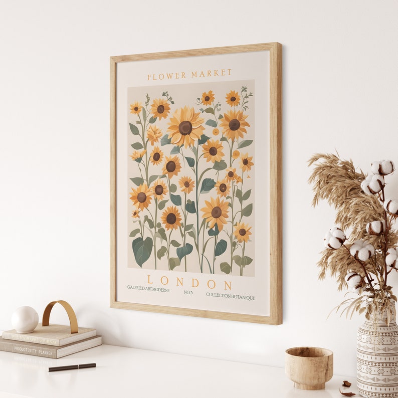 May include: A framed print of a botanical illustration featuring a cluster of sunflowers in shades of yellow and green. The print is titled "Flower Market London" and includes the text "Galerie d'Art Moderne No.3 Collection Botanique".