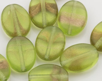 May include: A collection of oval-shaped glass beads with a light green color and a gold metallic stripe down the center. The beads have a translucent appearance.