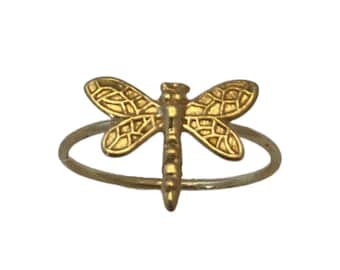 May include: A gold dragonfly ring with a delicate design. The ring is simple and elegant, perfect for everyday wear.
