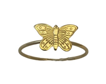 May include: A gold butterfly ring with a detailed design. The ring is simple and delicate, perfect for everyday wear.