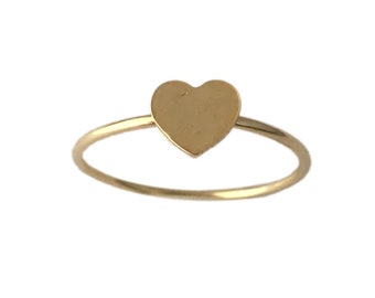 May include: A simple gold ring with a heart-shaped design.