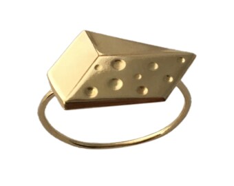May include: A gold ring with a cheese-shaped design. The cheese has holes and is a realistic representation of a block of Swiss cheese.