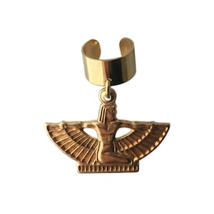 May include: Gold ear cuff with a dangling charm of an Egyptian goddess with outstretched wings.
