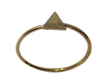 May include: A gold triangle ring with a simple, minimalist design.