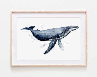May include: Watercolor painting of a humpback whale in shades of blue, swimming on a white background. The whale is depicted with detailed shading and splashes of blue. The artwork is framed in a light wood frame.