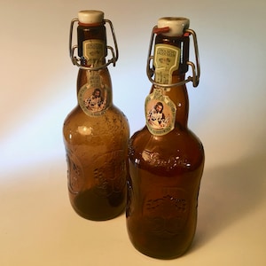 Pair of vintage Grolsch amber beer bottles with porcelain wired stopper