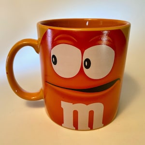 Collectible orange Crispy M&M extra large coffee mug made in Thailand