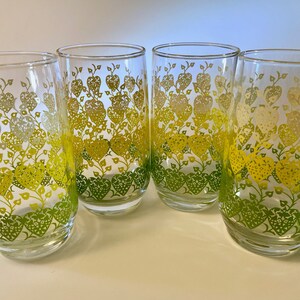 Set of five vintage glass tumblers with a heart and vine pattern in green, yellow, and white colors that blend together