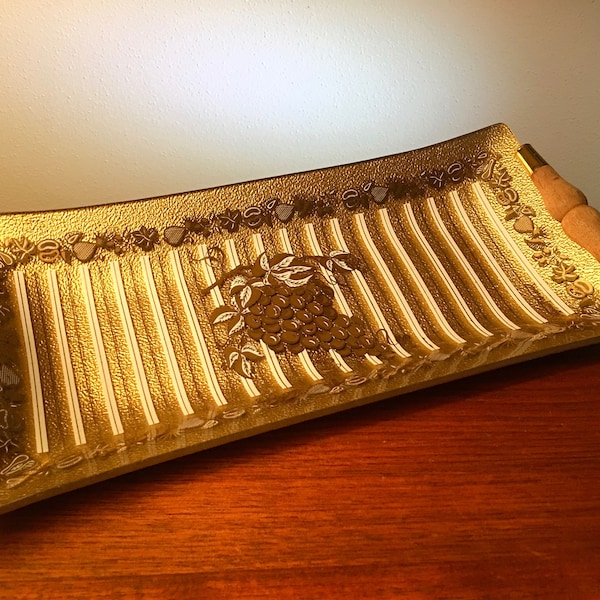 Fancy gold glass serving tray accented with brass and wood handles