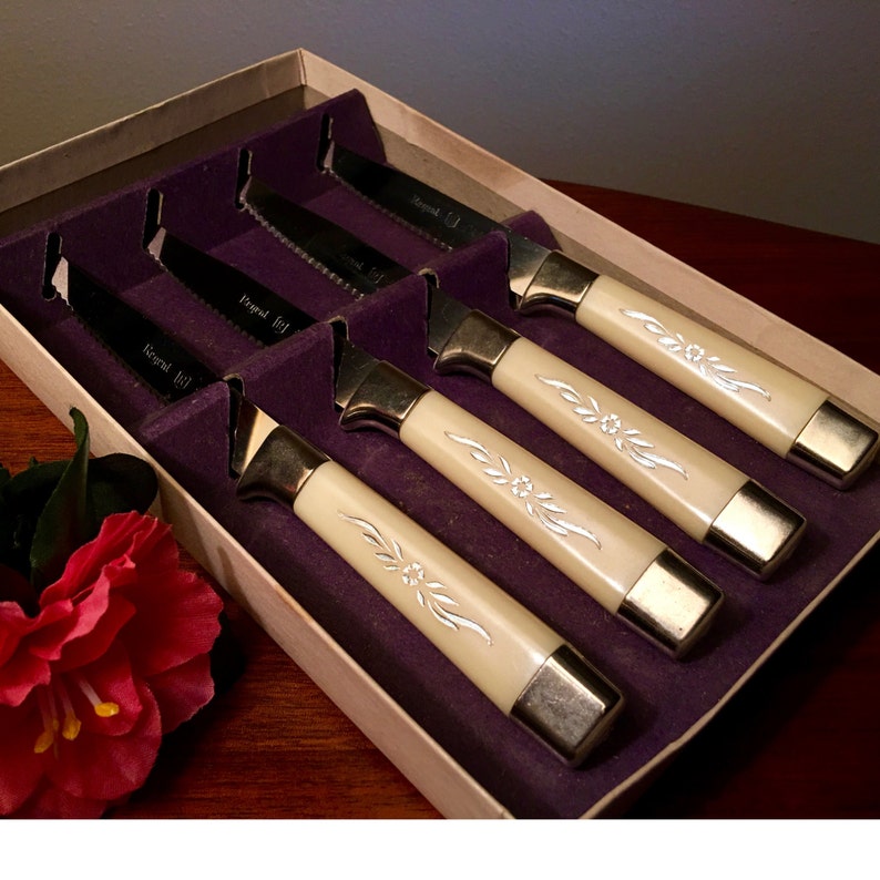 Set of four Regent Stainless steak knives with silver inlays