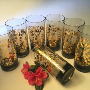 Set of seven tinted glass tumblers with fancy gold spiral design