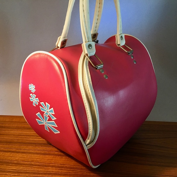 Retro bright pink vinyl bowling bag with blue atom