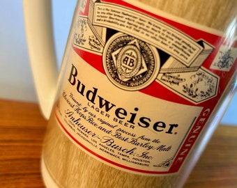 Vintage Budweiser Thermo-Serv plastic beer stein or mug from the 70s or 80s  with logo on faux wood background