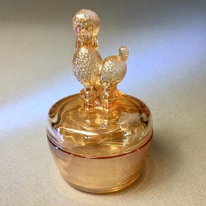 Vintage Jeannette iridescent marigold carnival glass poodle dog lidded powder, jewelry or trinket box - 6&quot; tall and 3.75&quot; in diameter