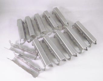 Set of 12 vintage French decorative pressed metal cutlery rests.